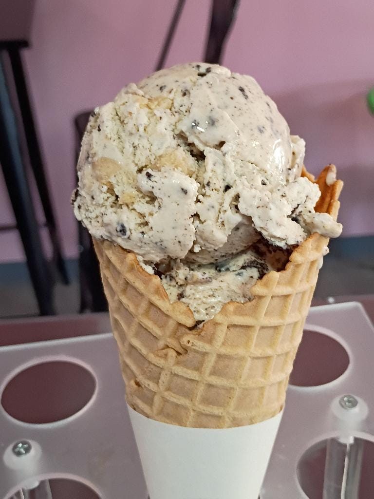A tall cone of pecan ice cream