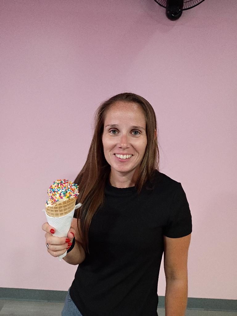Customer smiling with a sundae at Scoops