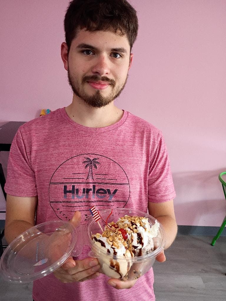 Guest with a large sundae at Scoops
