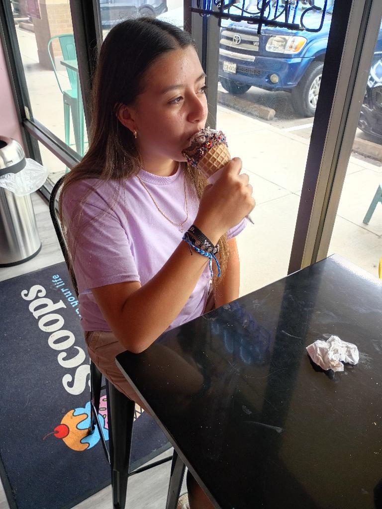 Guest enjoying a cone in the Scoops dining room