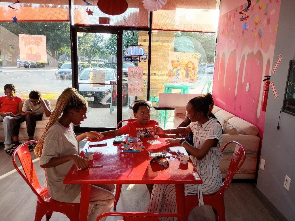 Guests enjoying ice cream inside the Scoops shop in Houston
