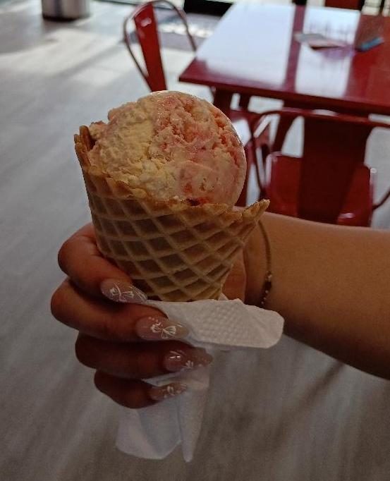 A waffle cone with strawberry ice cream